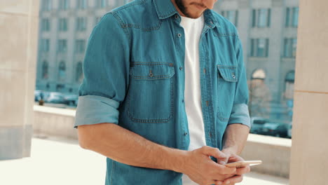 man using smartphone in city