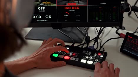 person operating a video production switcher for live streaming