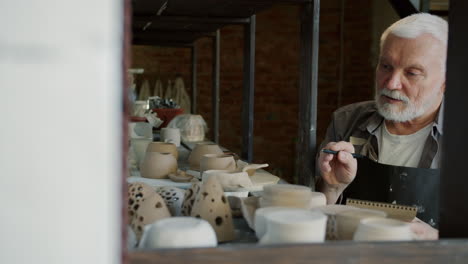 senior potter in his workshop