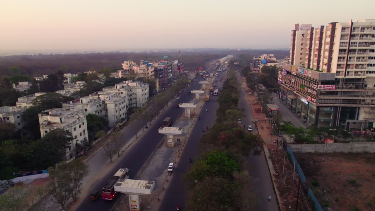 Under construction flyover with urban forest and haze at suchitra, hyderabad, telangana, india. day time, semi orbit, drone shot, 4k.