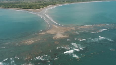 Drone-Aerial-over-the-shore-of-the-beach-with-whale-tail-shape