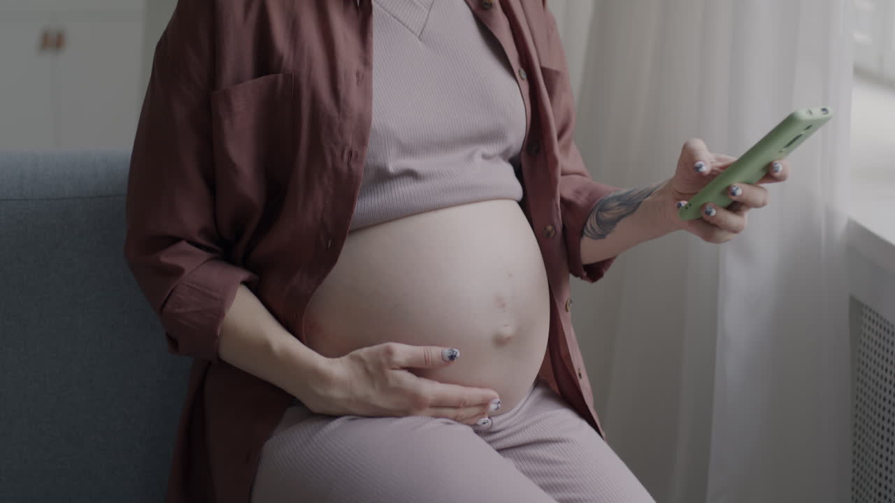 Pregnant woman using a phone