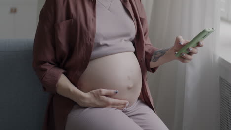 pregnant woman using a phone