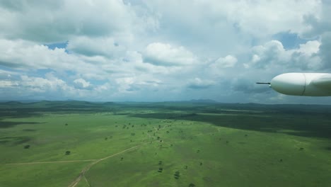 wing view from flight cessna 208b caravan from zanzibar to tanzania looking across vast landscape