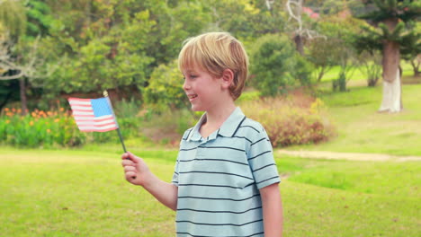 little boy holding american flag