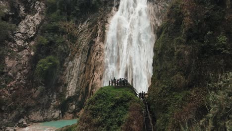 tourists on viewpoint admiring the beauty of el chiflon waterfall in chiapas, mexico