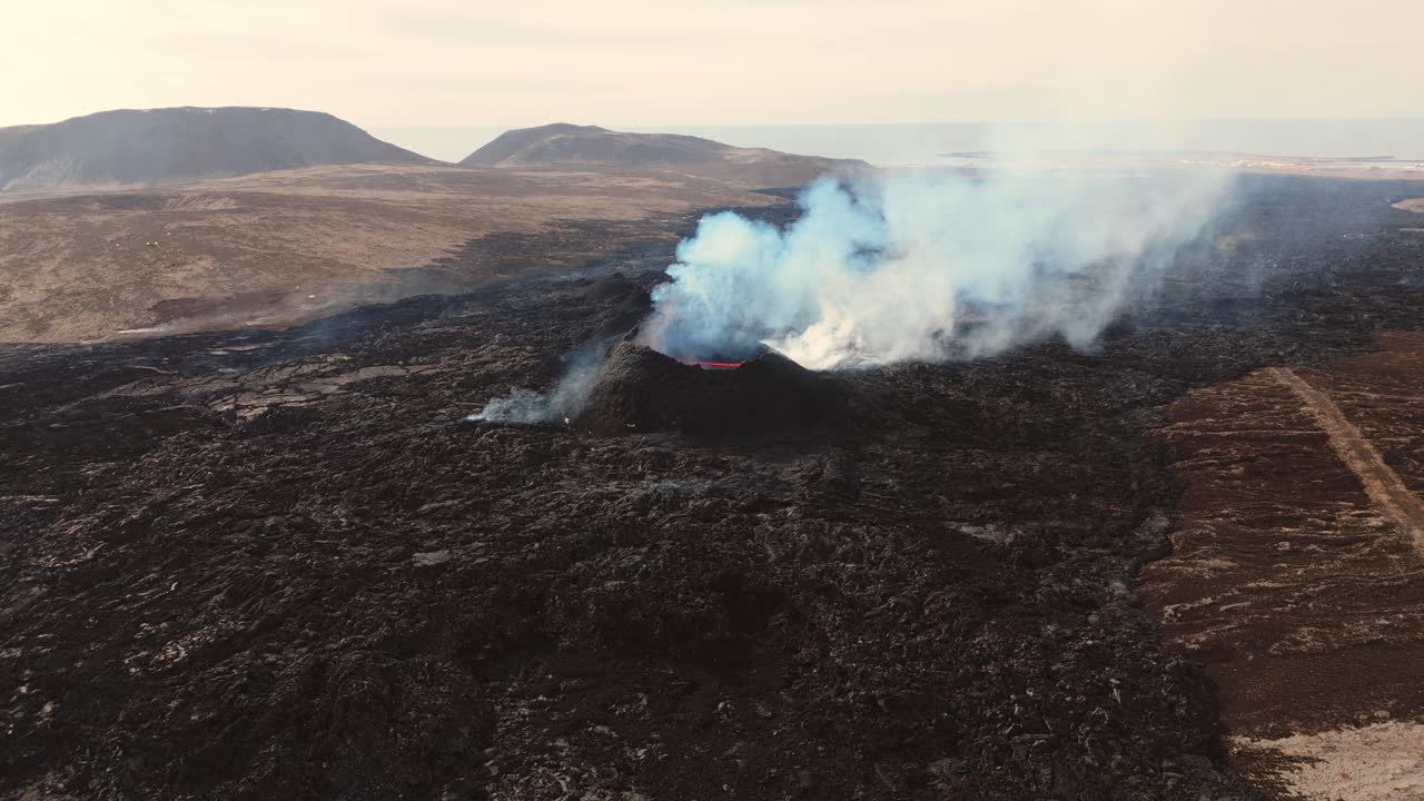 Erupting Grindavík volcano with smoking crater in barren landscape