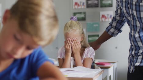 video of african american male teacher supporting sad caucasian girl