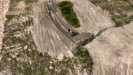 heavy machinery pushing dirt to create a level surface