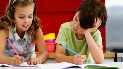 Siblings-doing-their-homework-in-kitchen