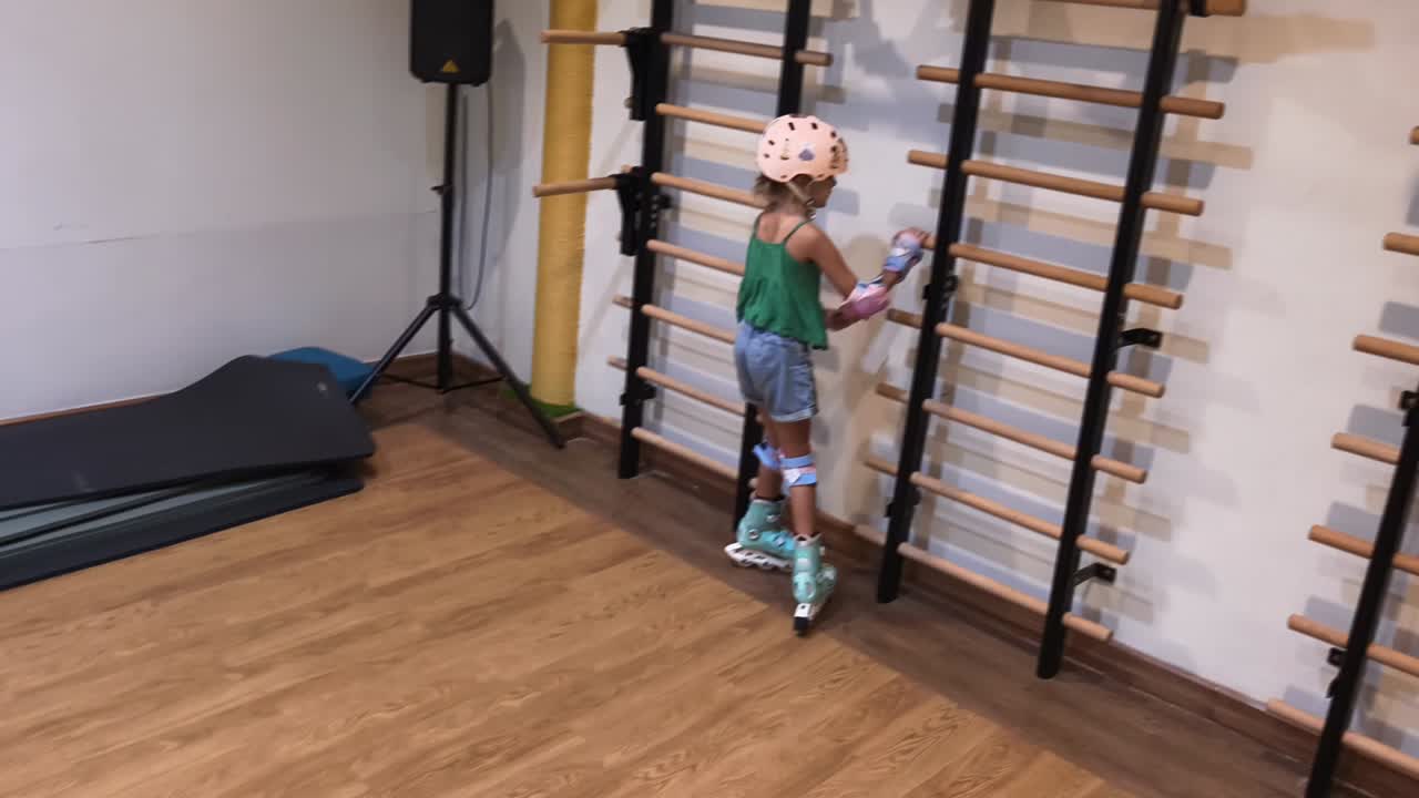 Young girl practicing roller skating in a gym