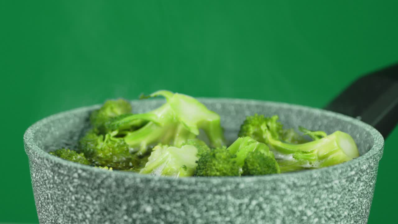 Fresh broccoli cooked in a saucepan.