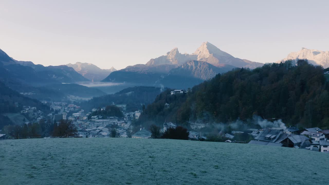 Autumn Landscape in Bavaria, Germany | 4K UHD D-LOG - Cold, misty sunrise Fall colours over Berchtesgarden Germany, featuring a cinematic drone shot of a chapel overlooking the town - mountains