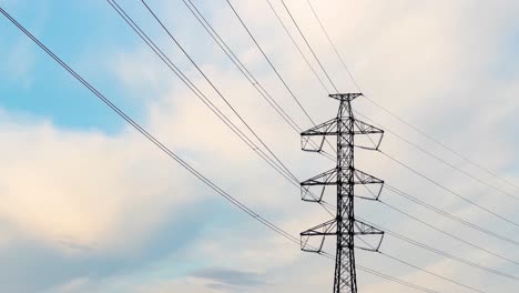 High-voltage-transmission-tower.-Clouds-moving-by.-Time-lapse