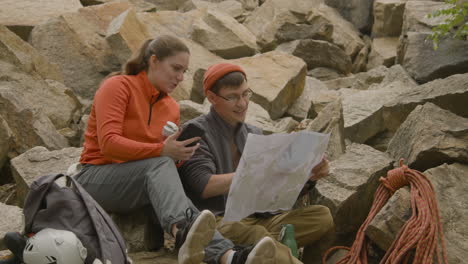 climbers sitting on a rock