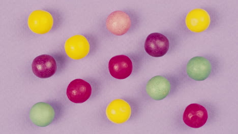 colorful round candies on purple background