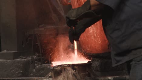 man mixing and melting iron on extreme heat conditions