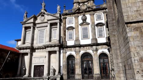 tilt down shot of saint francis church with bell tower and white facade, porto