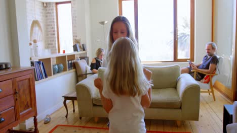 Siblings-dancing-together-in-living-room-4k