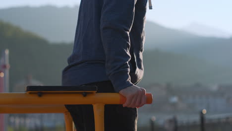 man performing dips outdoors