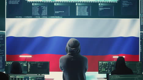 russian hacker with a hood installing panic by misconception and manipulation