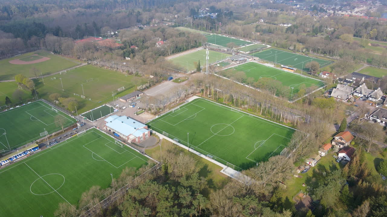 Aerial overview of green soccer fields at amateur sports club