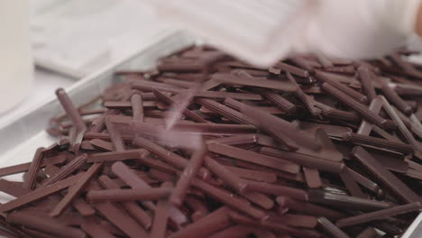 production of dark chocolate sticks, tray full of chocolate sticks