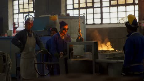 Workers-melting-metal-in-foundry-workshop-4k