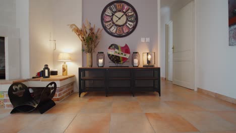 slow push in towards pampas grass and ornaments on a table in a house