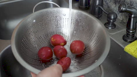 potatoes taking a bath in a colander