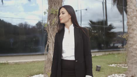 young professional woman standing waiting