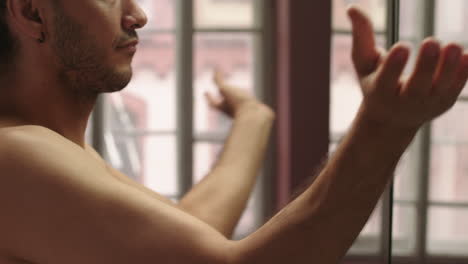 young man in front of a mirror