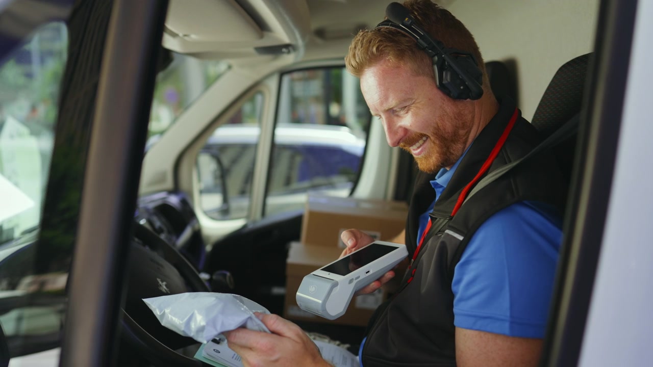 Delivery Driver Scanning Package in Van