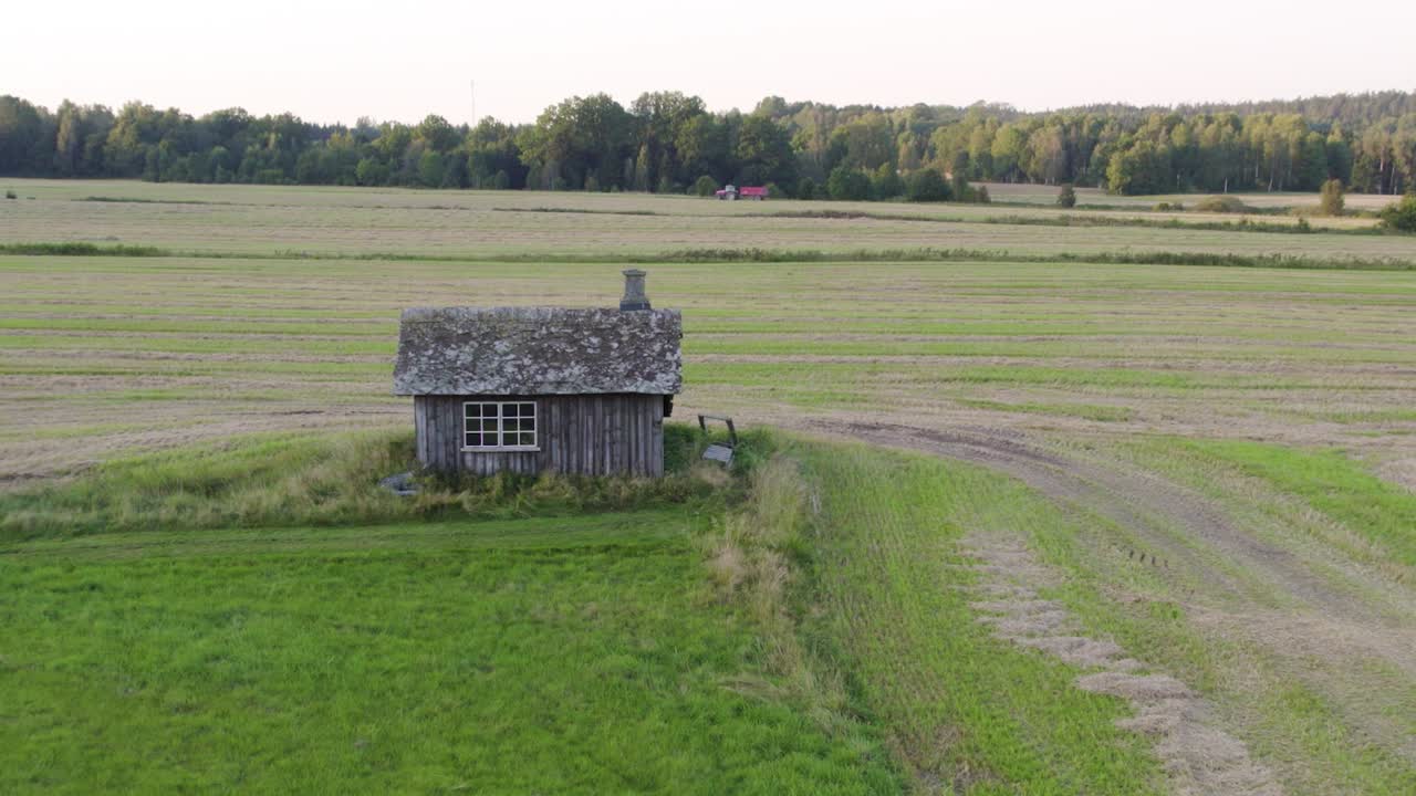 Old Swedish blacksmith workshop on farmland, calm nature surrounding it