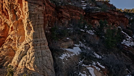 Aerial perspective highlighting a spectacular natural arch in Utah’s red rock terrain at sunrise.