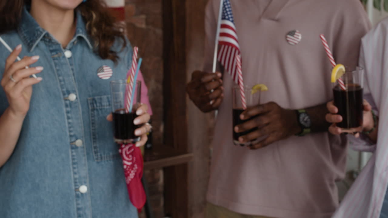 Friends Celebrating with Drinks and American Flags