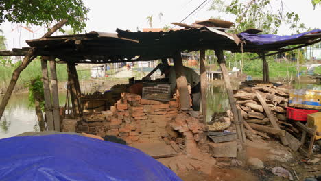 An-outside-view-of-a-small-pottery-shop-in-Thanh-Ha,-where-skilled-artisans-shape-and-mold-clay-into-beautiful-pottery-with-precision-and-expertise