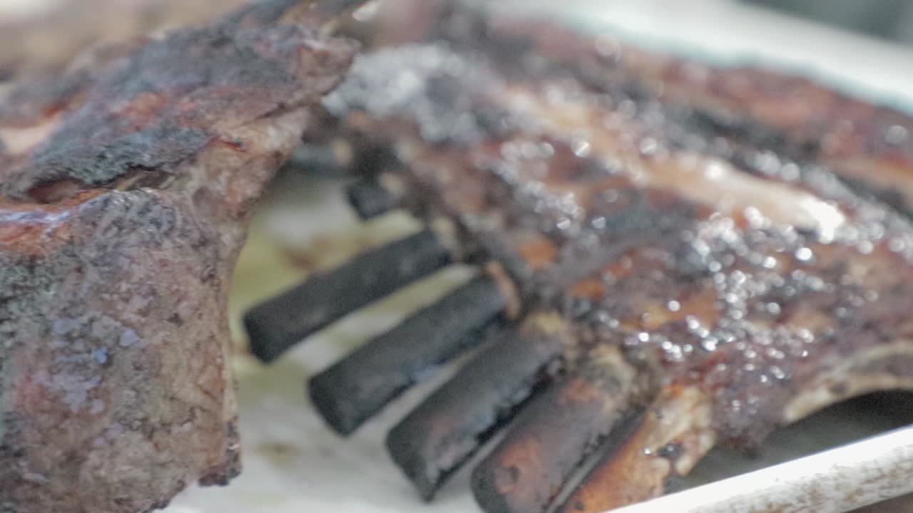 Beef Rib cooking on high heat barbecue. Slow Motion