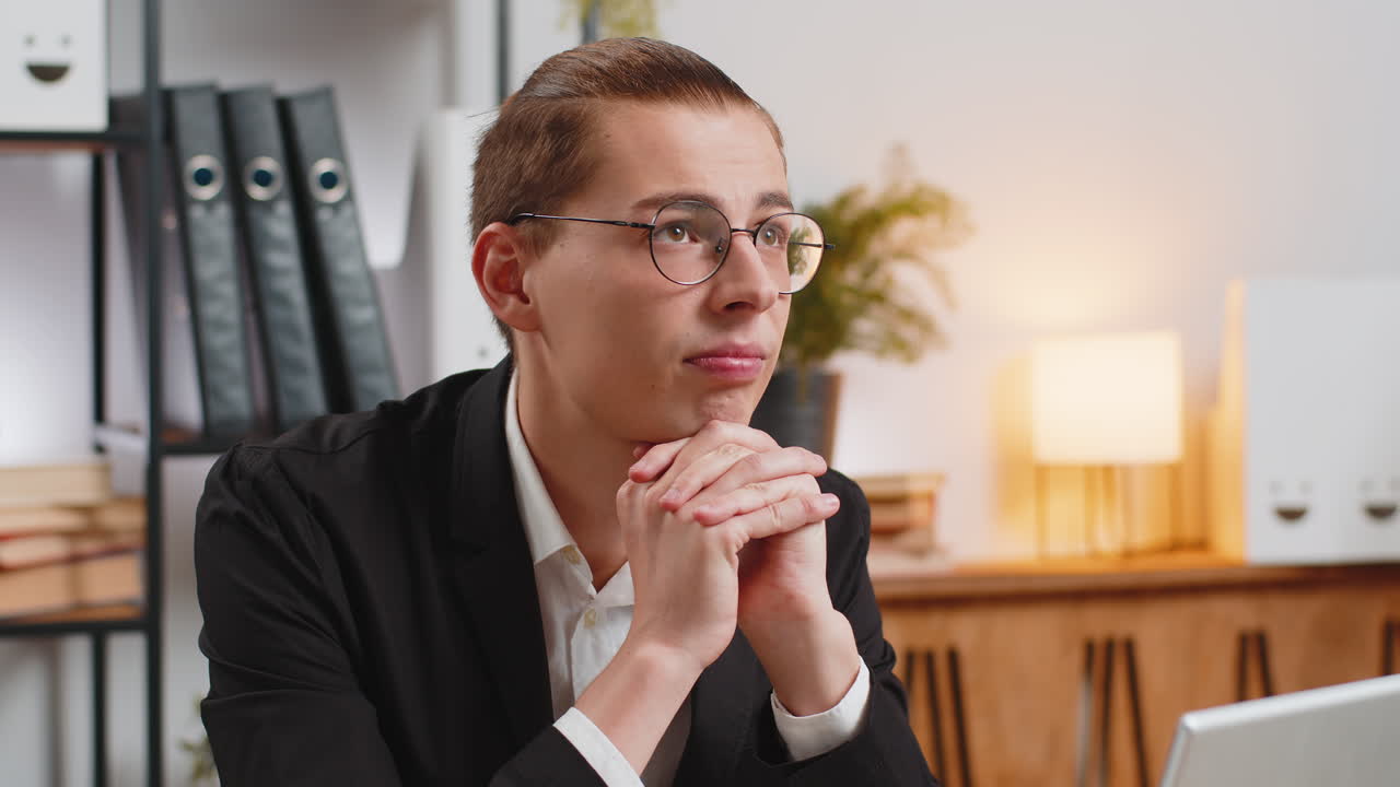 Tired pensive caucasian businessman thoughtful taking break after laptop work at home office desk