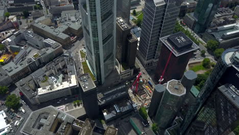 AERIAL:-Breathtaking-rising-View-of-Frankfurt-am-Main,-Germany-Skyline,-Sunny-with-Overcast