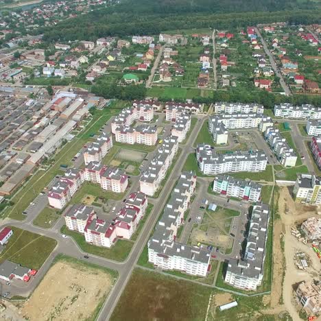 process of building modern high-rise buildings in the new part of the city. View of the buildings on the outskirts of the city. Aerial view.