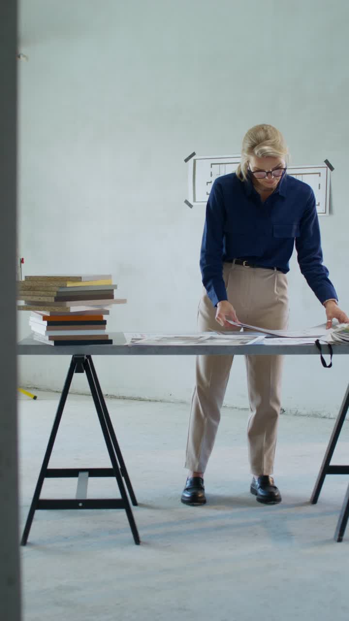 Architect reviewing design plans in a construction site