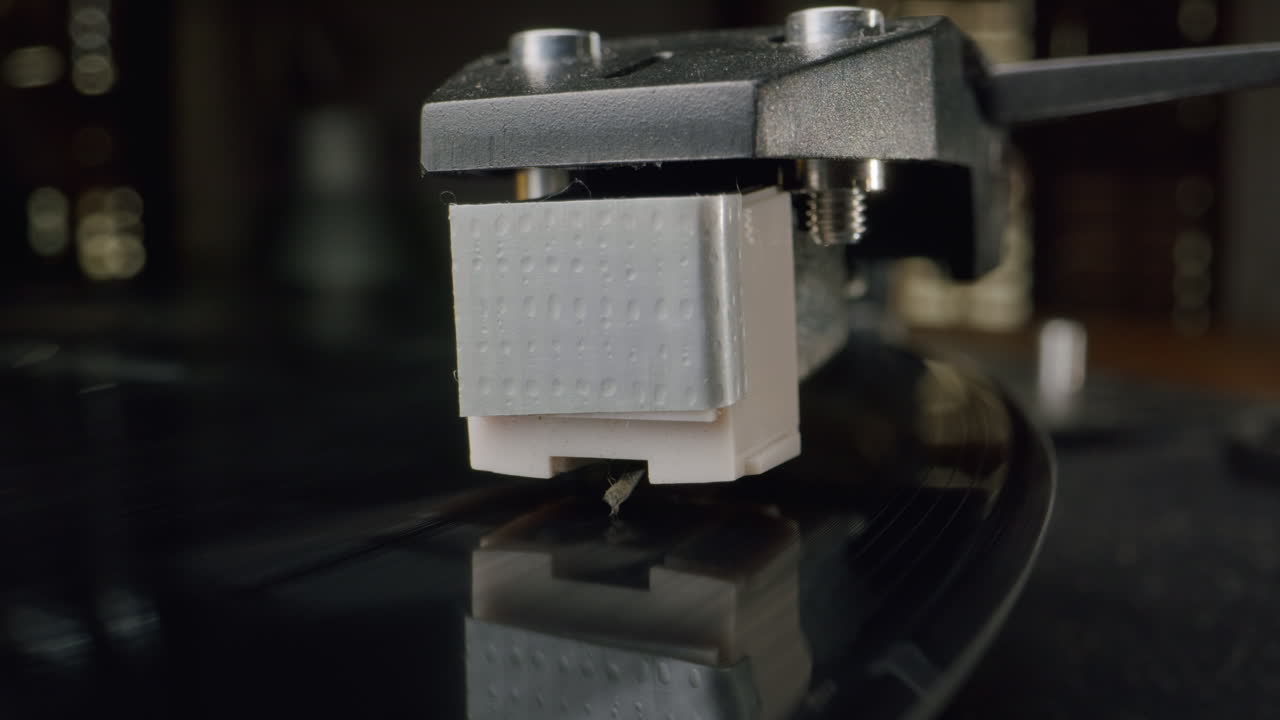 Close-up of a record player stylus playing a vinyl record