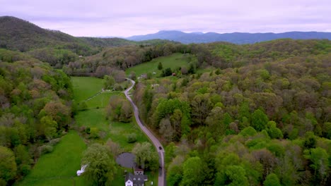 car drives down mountain valley roadway near boone and matney nc, north carolina