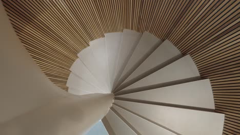 slow rotating shot up a small stunning wooden spiral staircase