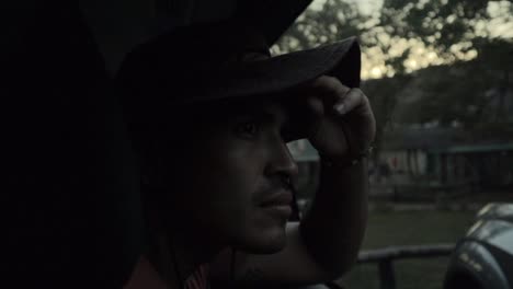 hispanic male with a hat sightseeing animals from inside a car at kruger national park south africa