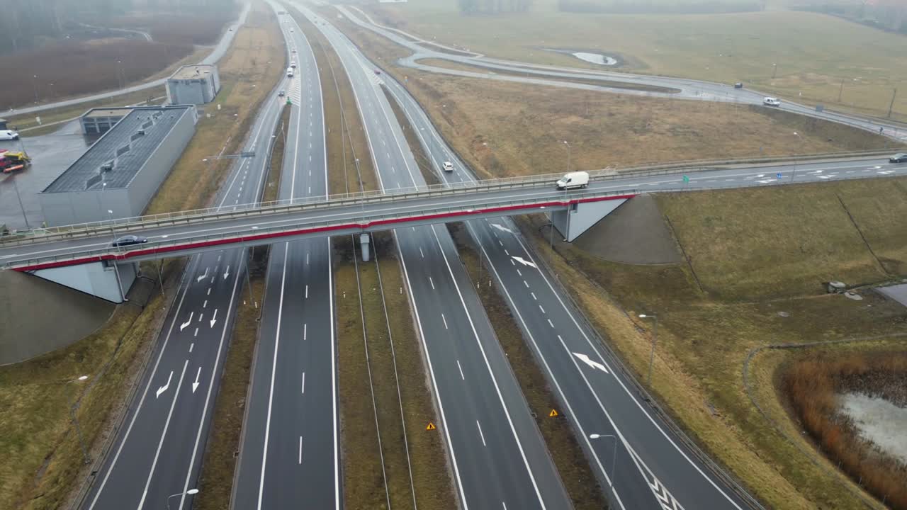 Highway Interchange in Autumn Fog with Cars and Overpass