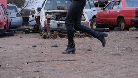 woman running through a dumpsite