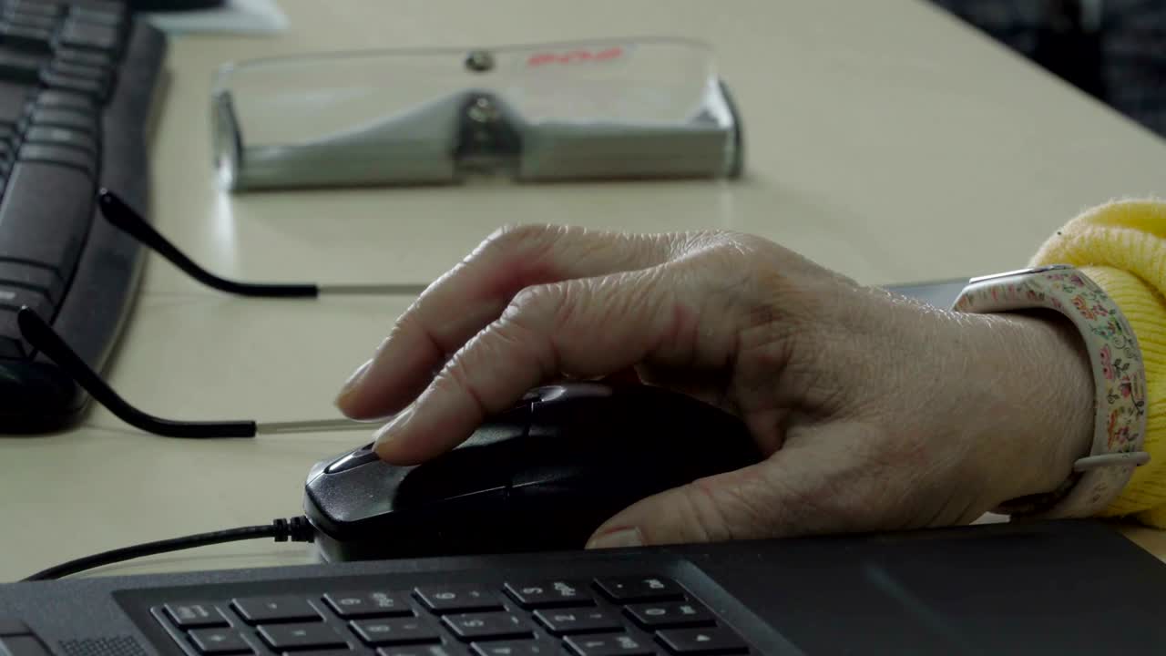 Senior woman using computer mouse