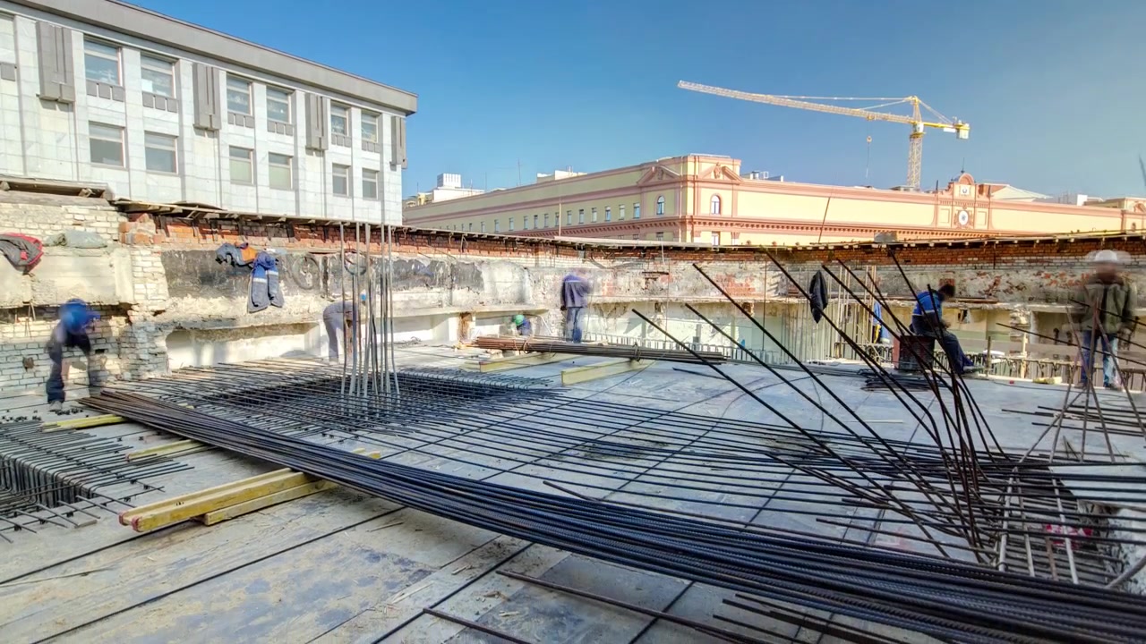 Steel bar rebar metal framework reinforcement for concrete at construction site timelapse. Metal wires works on a roof of new building in progress with many workers in uniform